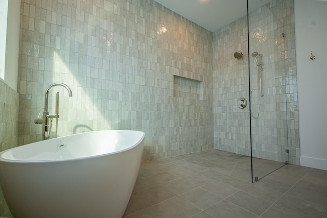 bathroom featuring tile walls, tile patterned flooring, and independent shower and bath