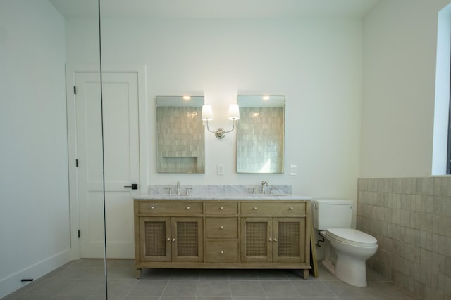 bathroom featuring tile walls, tile patterned flooring, toilet, and vanity