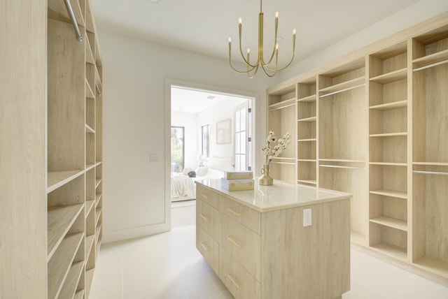 walk in closet with an inviting chandelier