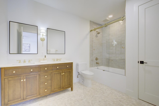 full bathroom featuring vanity, bath / shower combo with glass door, and toilet