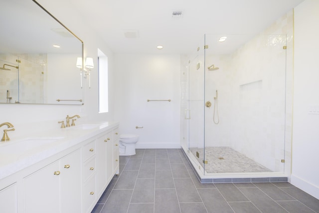 bathroom featuring vanity, toilet, an enclosed shower, and tile patterned flooring