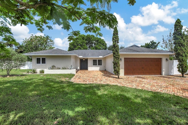 single story home with a garage and a front yard