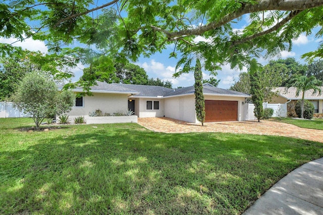 ranch-style home with a garage and a front lawn