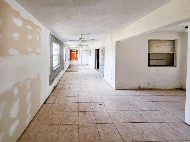 corridor featuring built in features and light tile patterned floors