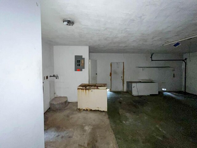 interior space with concrete flooring and electric panel