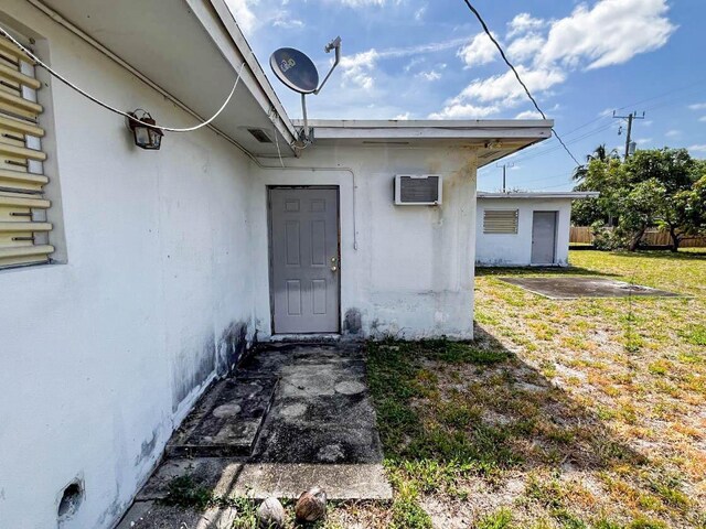 property entrance with a lawn