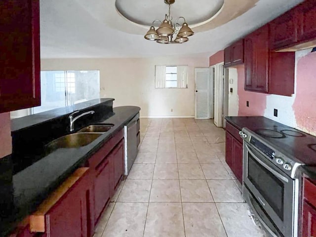 kitchen featuring dark countertops, stainless steel appliances, dark brown cabinets, and a raised ceiling