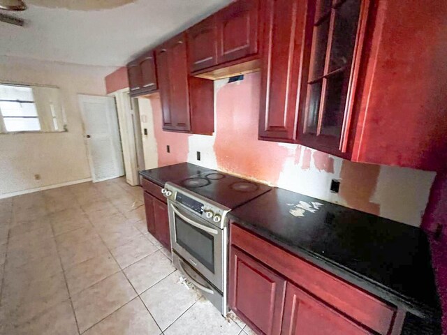 kitchen featuring range with two ovens and light tile patterned floors