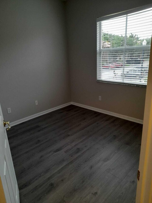 spare room featuring dark hardwood / wood-style floors