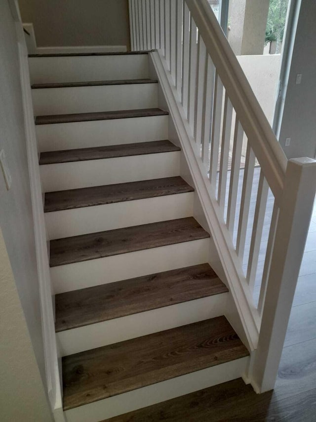 stairway featuring wood-type flooring