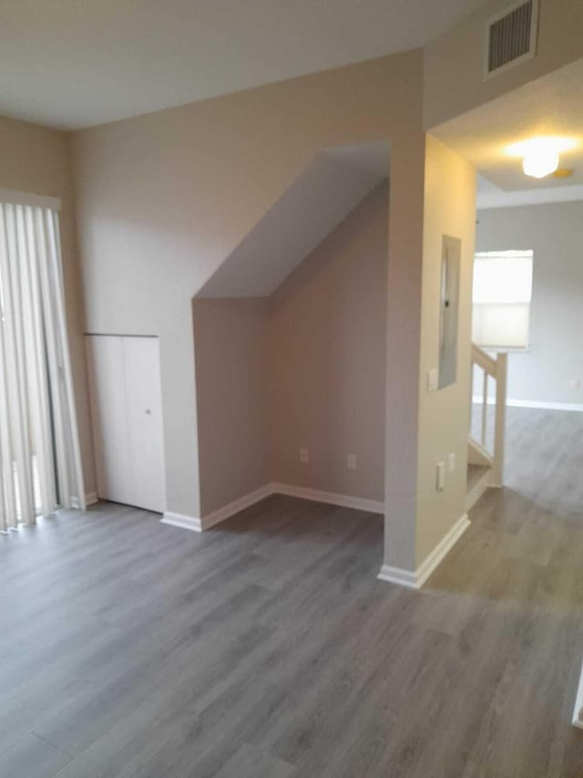 bonus room featuring hardwood / wood-style floors and electric panel