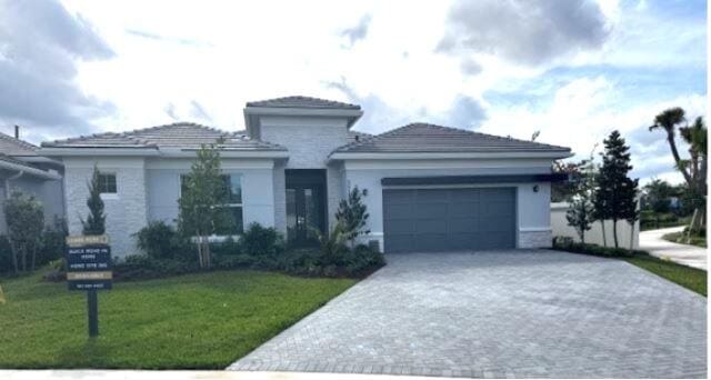 view of front of house featuring a front yard and a garage