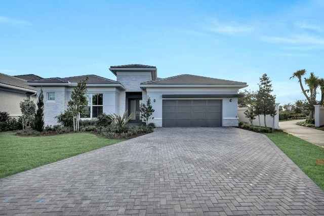 view of front facade with a garage and a front lawn