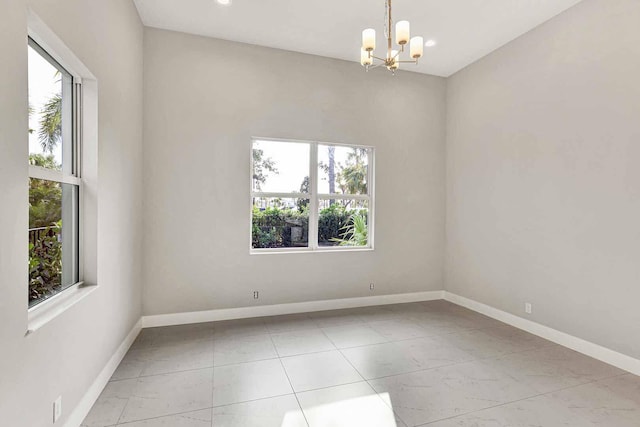 empty room with a chandelier and a wealth of natural light