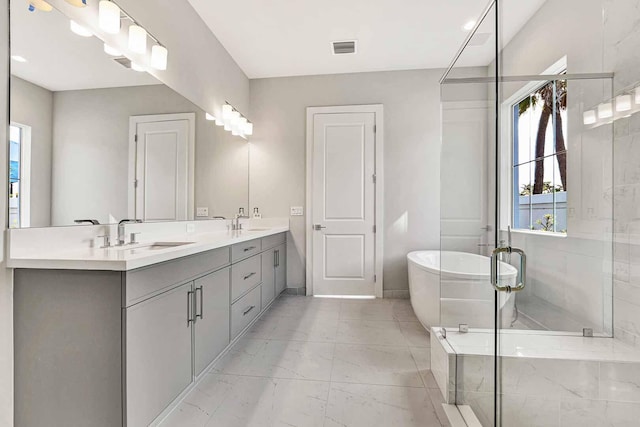 bathroom featuring shower with separate bathtub and vanity