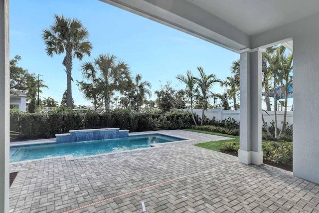 view of swimming pool with pool water feature and a patio area