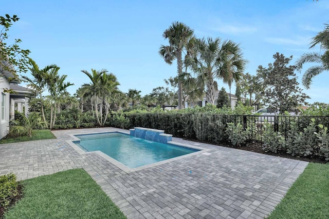 view of pool featuring pool water feature and a patio