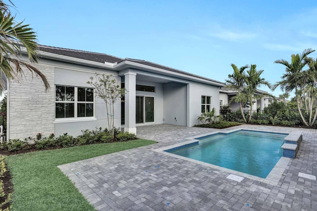 view of swimming pool featuring a lawn and a patio