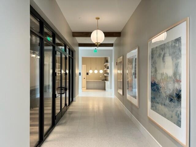 corridor featuring french doors and beamed ceiling