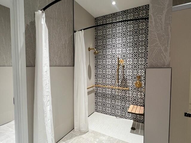 bathroom featuring vanity and tile walls