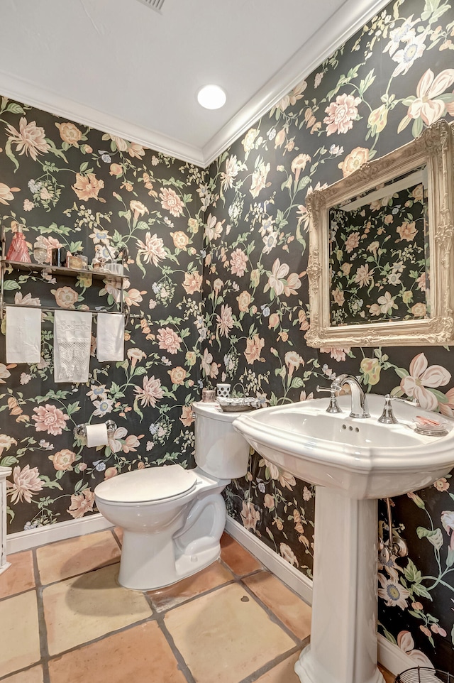 bathroom with toilet, tile patterned floors, and crown molding