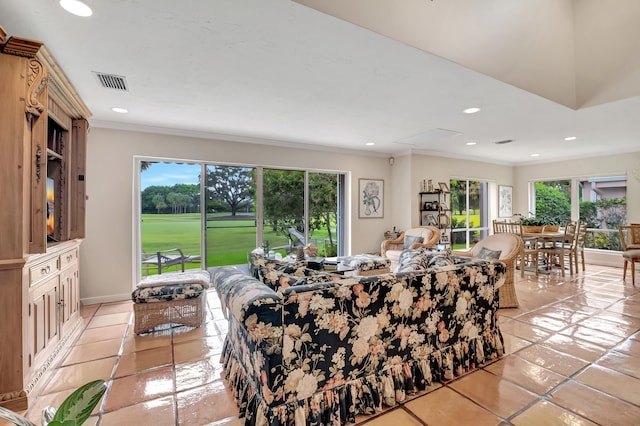 living room with ornamental molding, a healthy amount of sunlight, and light tile patterned floors