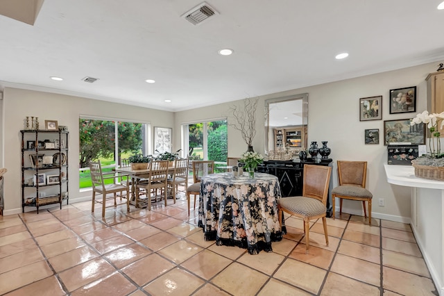 living room with crown molding and light tile patterned floors