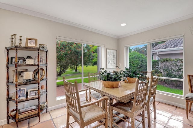 tiled dining space featuring crown molding and plenty of natural light