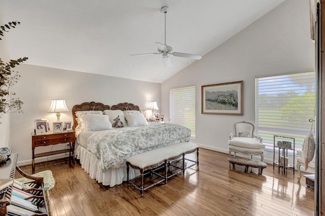 bedroom featuring hardwood / wood-style flooring, high vaulted ceiling, and ceiling fan