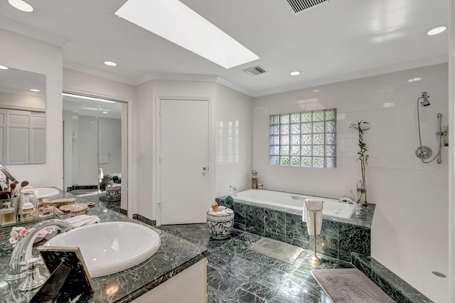 bathroom with tile patterned flooring, vanity, crown molding, a skylight, and shower with separate bathtub