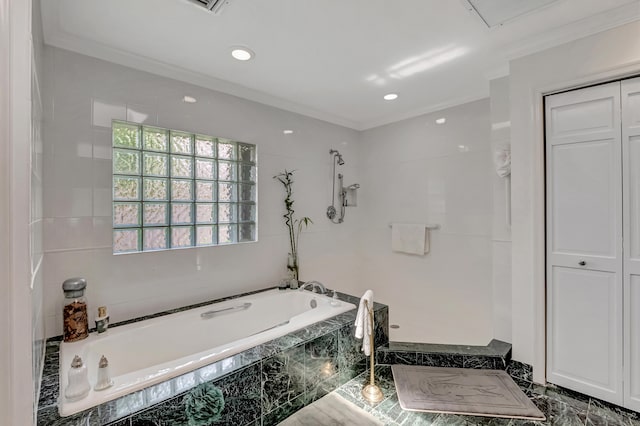 bathroom with a relaxing tiled tub, tile patterned floors, and ornamental molding