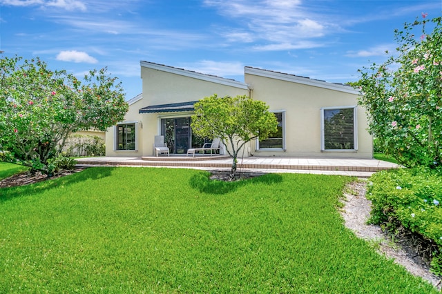 rear view of property with a lawn