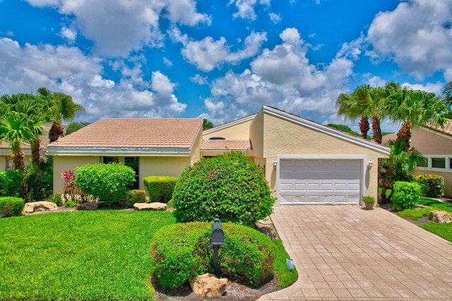 view of front facade with a garage and a front yard