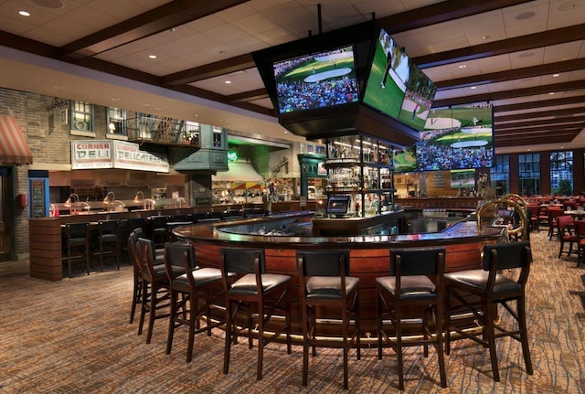 bar featuring beamed ceiling and carpet flooring