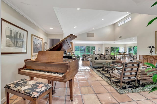 misc room with ornamental molding, light tile patterned flooring, and a high ceiling