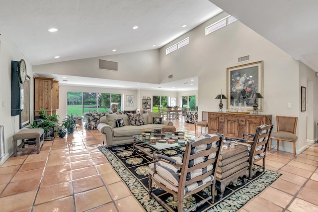 living room featuring light tile patterned floors and high vaulted ceiling