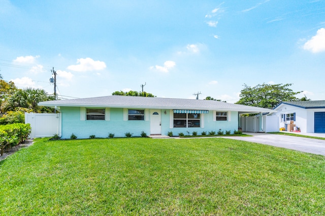 ranch-style house featuring a garage and a front lawn