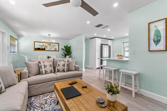9531 Birdwood St, Palm Beach Gardens, FL 33410 - living area with baseboards, light wood-style flooring, recessed lighting, a chandelier, and a ceiling fan