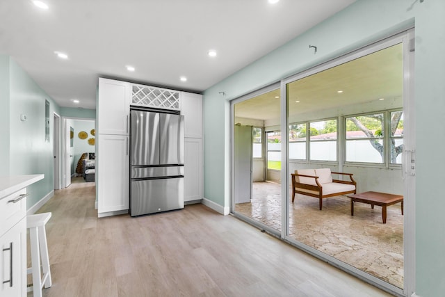 9531 Birdwood St, Palm Beach Gardens, FL 33410 - kitchen featuring freestanding refrigerator, white cabinets, light wood-style flooring, recessed lighting, and light countertops