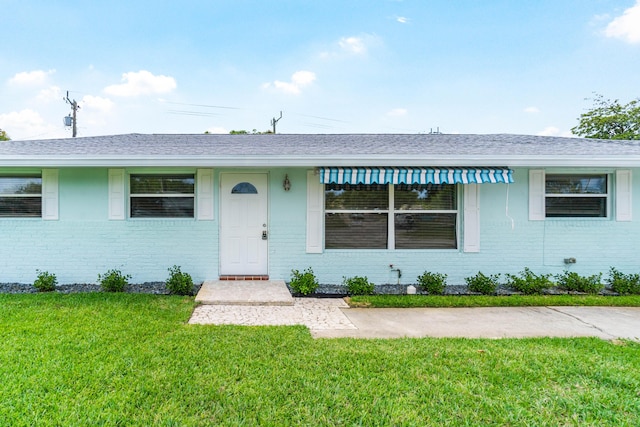 9531 Birdwood St, Palm Beach Gardens, FL 33410 - view of front of property featuring brick siding and a front yard