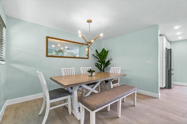 9531 Birdwood St, Palm Beach Gardens, FL 33410 - dining area with light wood-style flooring, baseboards, and a chandelier