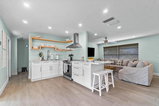 9531 Birdwood St, Palm Beach Gardens, FL 33410 - kitchen with wall chimney range hood, stainless steel electric stove, open shelves, open floor plan, and light countertops