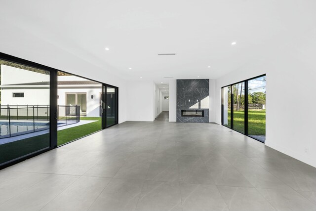 unfurnished living room featuring a premium fireplace