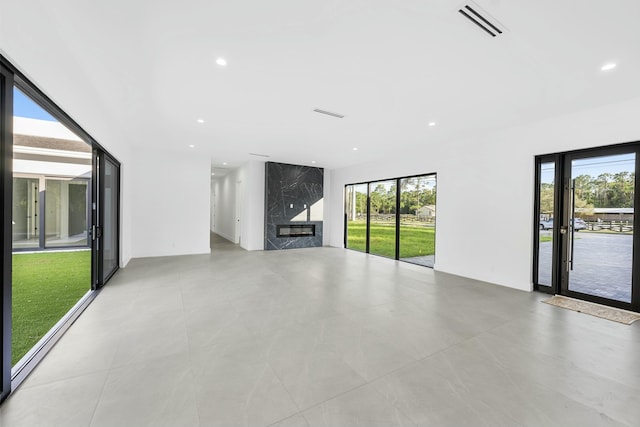 unfurnished living room featuring a high end fireplace