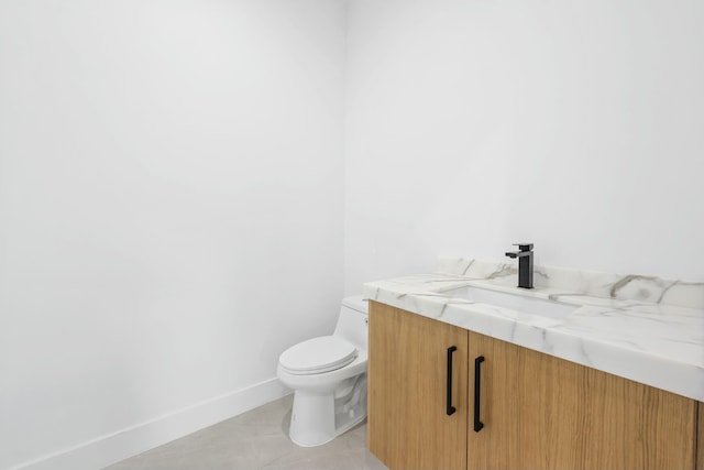 bathroom featuring tile patterned floors, vanity, and toilet