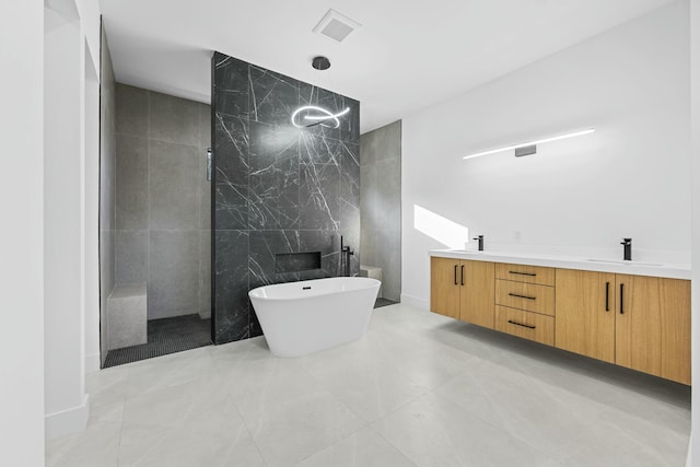 bathroom with tile patterned flooring, plus walk in shower, tile walls, and vanity