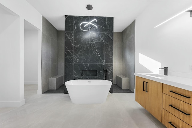 bathroom with vanity, a bathing tub, tile walls, and a notable chandelier