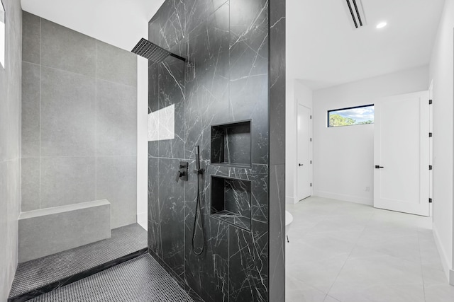 bathroom with a shower and tile walls