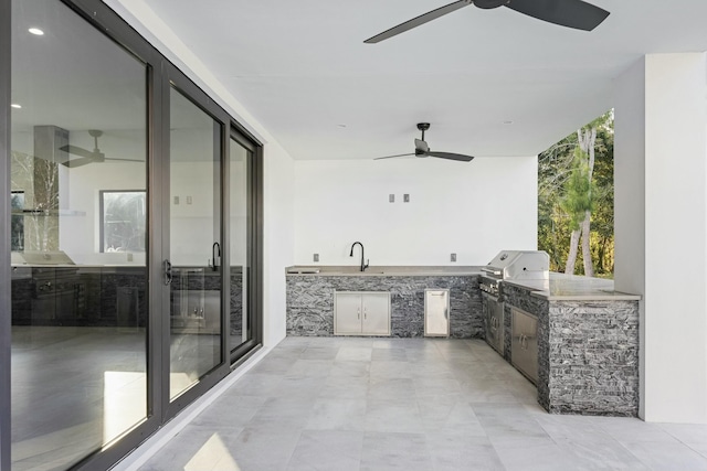 view of patio / terrace with ceiling fan, grilling area, exterior kitchen, and sink