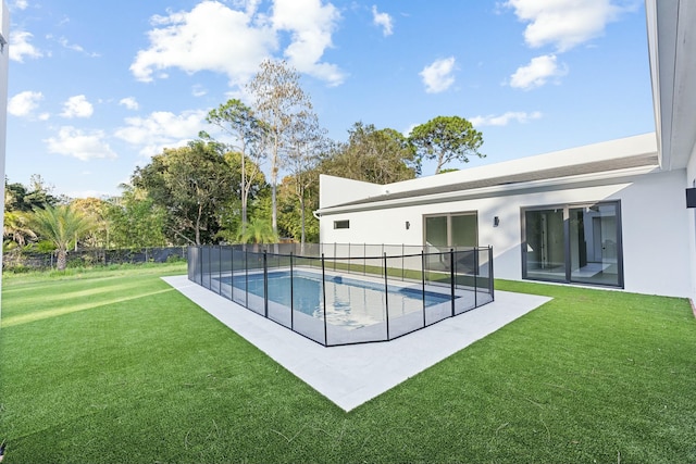 view of swimming pool with a patio and a yard